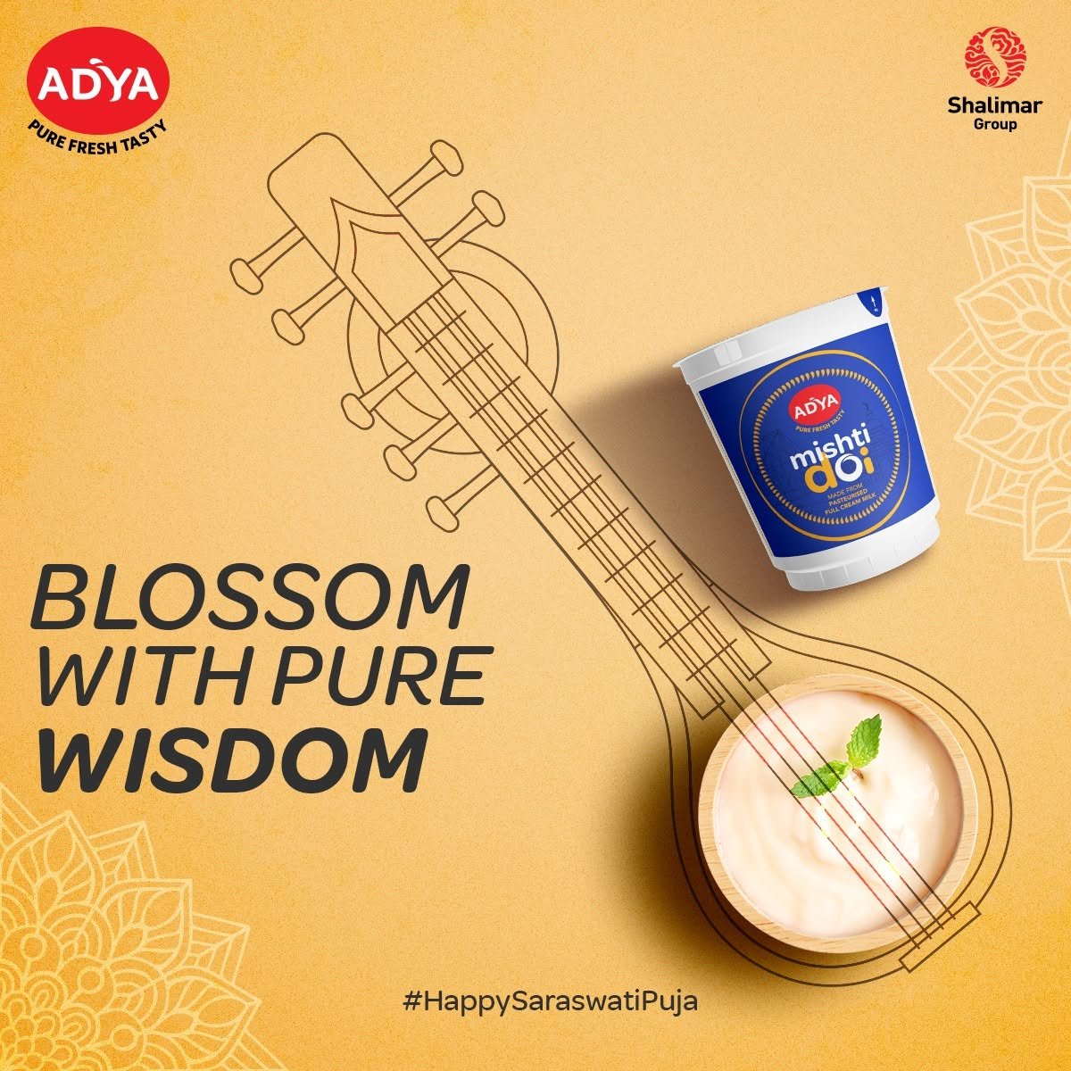 Adya Dairy Saraswati Puja creative featuring a veena illustration, Mishti Doi packaging and a bowl of sweet curd on a golden background.