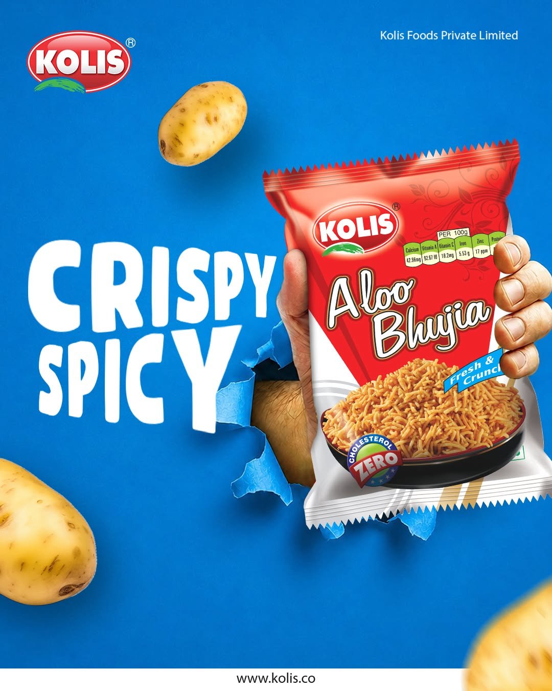 Kolis Aloo Bhujia advertising creative featuring a red snack packet emerging from a blue background with potatoes and bold Crispy Spicy typography.